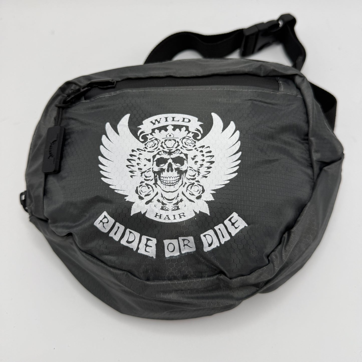 Black bag with a white skull design and 'Ride or Die' text on a light gray background