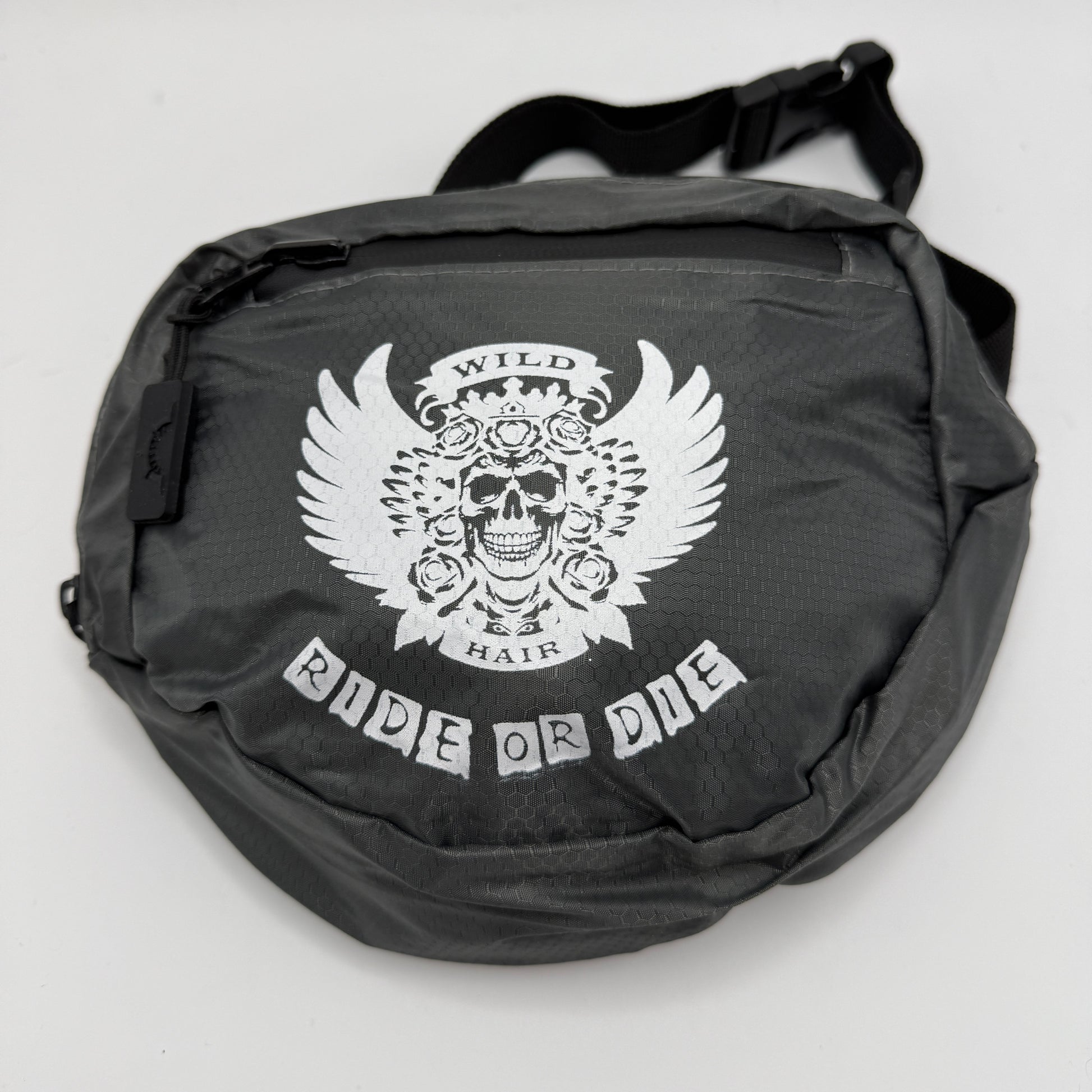 Black bag with a white skull design and 'Ride or Die' text on a light gray background