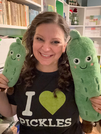Author JJ Knight with the small and large dill the pickle stuffed animals ￼