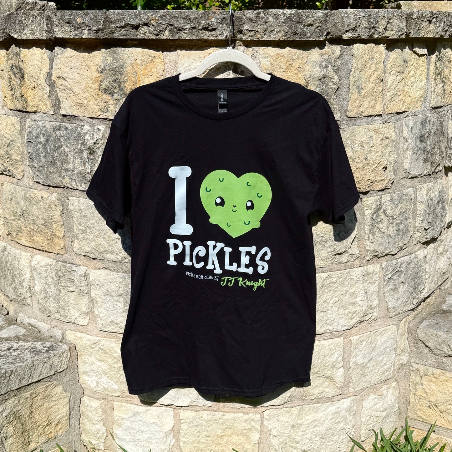 Black t-shirt with 'I ❤️ Pickles' design on a stone wall background