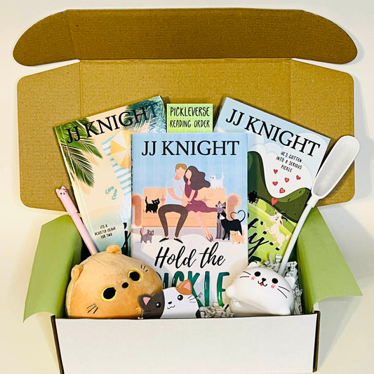 Pickle Cousins trilogy box with Juicy Pickle, Hold the Pickle, and Salty Pickle by JJ Knight with cat lamp and kitty stuffy