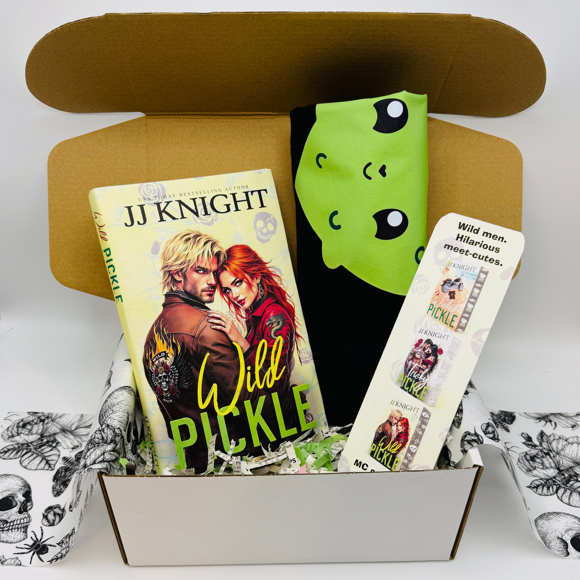 Book titled 'Wild Pickle' by JJ Knight with a pickle Tshirt and bookmark in a box.