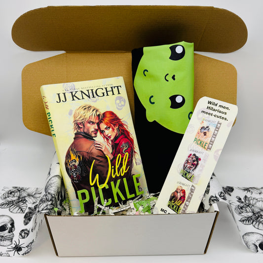 Book titled 'Wild Pickle' by JJ Knight with a pickle Tshirt and bookmark in a box.