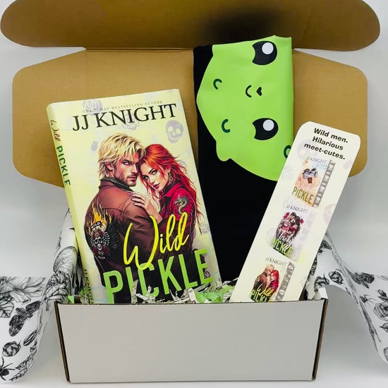 Book titled 'Wild Pickle' by JJ Knight with a pickle Tshirt and bookmark in a box.