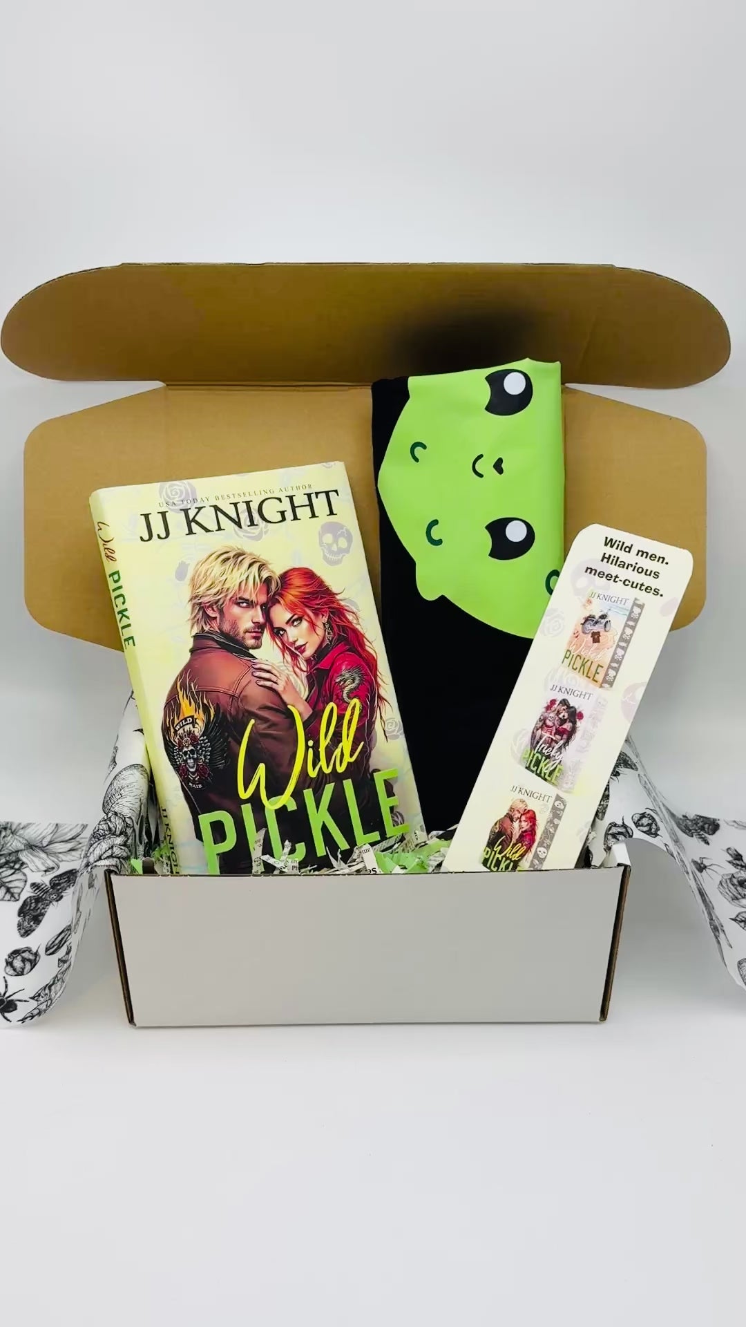 Book titled 'Wild Pickle' by JJ Knight with a pickle Tshirt and bookmark in a box.