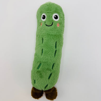 Green plush toy resembling a pickle on a white background